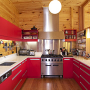 Cedar cladding wraps the exterior of this Lockwood ceiling, countertop, cuisine classique, interior design, kitchen, real estate, room, red, orange