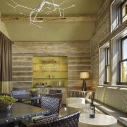 In this rustic mountain house in Montana, the ceiling, home, interior design, living room, lobby, room, wall, brown