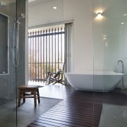 The shower area in this opnen-plan master suite architecture, bathroom, ceiling, daylighting, floor, flooring, glass, home, interior design, room, tile, window, gray, black