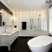 In this master bathroom, walls feature large tiles bathroom, home, interior design, property, real estate, room, sink, window, white, black