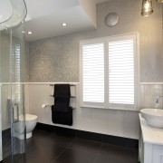 The custom mirror in the guest bathroom features bathroom, floor, home, interior design, property, real estate, room, sink, tile, gray