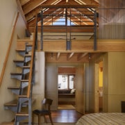 This guest suite builds on the exposed structural beam, ceiling, interior design, stairs, wood, brown