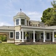 This John Malick-designed house has an air of cottage, elevation, estate, facade, farmhouse, grass, historic house, home, house, landscaping, lawn, mansion, orangery, plantation, porch, property, real estate, residential area, siding, villa, brown, teal