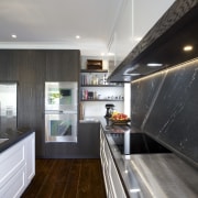 This classic kitchen by Robyn Labb offers modern cabinetry, ceiling, countertop, house, interior design, kitchen, real estate, room, gray