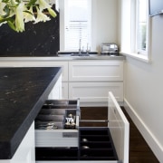 This classic kitchen by Robyn Labb offers modern cabinetry, countertop, floor, furniture, hardwood, home, interior design, kitchen, room, gray