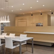 The kitchen in this desert house incorporates a ceiling, conference hall, dining room, floor, flooring, furniture, interior design, real estate, room, table, brown, gray