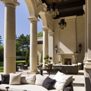 This loggia, at the rear of a large architecture, column, estate, furniture, home, interior design, living room, structure, window, brown