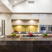 The backsplash in the kitchen and pantry is countertop, interior design, kitchen, living room, lobby, real estate, white