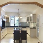 The island tabletop in this contemporary classic kitchen cabinetry, ceiling, countertop, cuisine classique, interior design, kitchen, property, real estate, room, gray