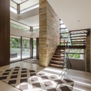 The glazed, double-height entry to this contemporary home architecture, ceiling, daylighting, floor, flooring, home, house, interior design, lobby, stairs, wood, gray, brown