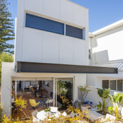 The ground floor of this terrace-style home opens architecture, building, elevation, facade, home, house, property, real estate, residential area, window, gray