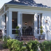 A steeply pitched gable roof and traditional detailing backyard, cottage, facade, home, house, outdoor structure, porch, property, real estate, siding, window, yard, gray