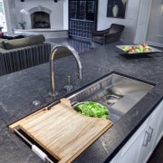 This Mick De Giulio  kitchen responds to countertop, floor, flooring, interior design, kitchen, sink, table, gray