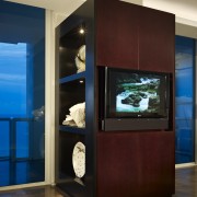 A large cabinet conceals a structural wall pillar furniture, home appliance, interior design, red