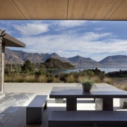 In this lakeside house, wood veneer ceilings run architecture, estate, home, house, interior design, landscape, property, real estate, sky, gray