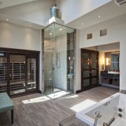 Large vanity mirrors reflect the view. The vanity ceiling, floor, flooring, interior design, living room, lobby, real estate, gray