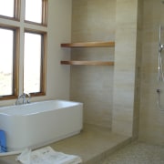 A sunken bathtub on an elevated platform is architecture, bathroom, floor, flooring, home, interior design, plumbing fixture, room, sink, tile, wall, gray, brown