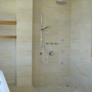 There is a distinctive Asian look to the bathroom, floor, plumbing fixture, room, shower, tile, wall, gray