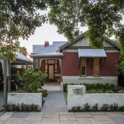 This Edwardian villa, built in the 1900s, retains architecture, cottage, estate, facade, farmhouse, home, house, mansion, neighbourhood, outdoor structure, property, real estate, residential area, suburb, tree, yard, gray