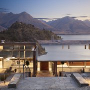 With a slender profile and a pitch that architecture, evening, home, house, mountain, mountain range, real estate, reflection, sky, water, wood, gray