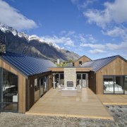 Cost-effective Heritage-Tray roofing  with custom flashing requires architecture, cottage, elevation, facade, home, house, hut, property, real estate, roof, siding, sky, teal, gray