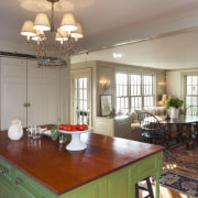This kitchen blends with its surroundings through architectural cabinetry, ceiling, countertop, dining room, home, house, interior design, kitchen, living room, real estate, room, table, window, gray