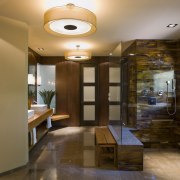This walk-in shower is tiled in tortoiseshell glass. ceiling, interior design, lobby, room, brown