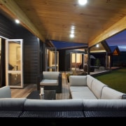 With its soaring timber lined gable roofs and architecture, ceiling, estate, home, house, interior design, lighting, living room, property, real estate, black, brown