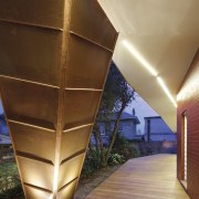 The design of the cladding references the traditional architecture, daylighting, light, lighting, wood, brown, orange