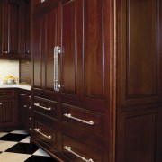 In this kitchen remodel, low-set drawers contain pots cabinetry, chest of drawers, closet, countertop, cupboard, drawer, furniture, hardwood, kitchen, room, wardrobe, wood, wood stain, red