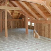 This home looks the part in a winter attic, beam, daylighting, floor, flooring, hardwood, home, house, log cabin, lumber, property, real estate, roof, room, structure, wall, wood, wood flooring, wood stain, orange, brown, gray