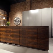 With its sleek, streamlined aesthetics, this kitchen blends cabinetry, chest of drawers, furniture, interior design, kitchen, sideboard, wood, wood stain, brown, gray