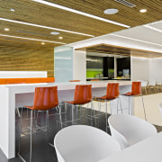 Bright orange and green enliven the staff pantry architecture, cafeteria, ceiling, conference hall, interior design, office, product design, table, white