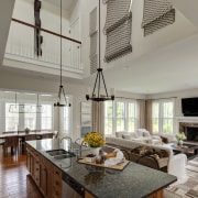 This granite-topped kitchen island, in a double-height open-plan ceiling, countertop, cuisine classique, home, interior design, kitchen, living room, gray, brown