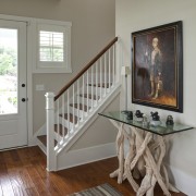 A stairway in the front entry of a baluster, bed, bed frame, floor, flooring, furniture, handrail, hardwood, home, house, interior design, laminate flooring, living room, product, room, stairs, table, wall, window, wood, wood flooring, wood stain, gray