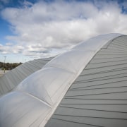 The roof was chosen in part for its architecture, atmosphere of earth, cloud, daylighting, daytime, line, roof, sky, structure, sunlight, gray