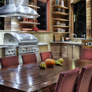 Rustic, weathered ipe siding lines the interior of countertop, dining room, furniture, home, interior design, kitchen, living room, table, wood, red