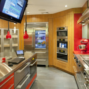 Cabinets in this test kitchen feature a mix countertop, interior design, kitchen, real estate, orange, brown