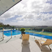Infinity pool for country house by Mayfair Pools. estate, home, house, leisure, property, real estate, sky, swimming pool, vacation, villa, gray