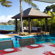 Multi-coloured pool tiles connect to the view and leisure, outdoor structure, property, real estate, resort, swimming pool, table, vacation, villa, gray