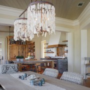 The dining area of this family room includes ceiling, chandelier, dining room, home, interior design, living room, real estate, room, window, gray