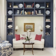 Interior is by Carl Belz and Associates.  bookcase, furniture, home, interior design, living room, room, shelf, shelving, gray