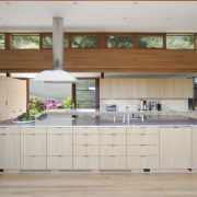 Clerestory windows provide views of the hillside behind cabinetry, countertop, cuisine classique, hardwood, interior design, kitchen, room, gray