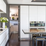 Contemporary kitchen with marble benchtop, handleless cabinetry and countertop, interior design, kitchen, white