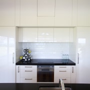 A Smeg 60cm induction cooktop and a concealed architecture, cabinetry, countertop, daylighting, interior design, kitchen, product design, room, under cabinet lighting, gray, white