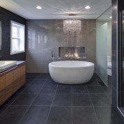 With glittering reflections, dancing flames and smooth textures, architecture, bathroom, floor, flooring, interior design, room, tile, black, gray