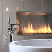 With glittering reflections, dancing flames and smooth textures, fireplace, hearth, plumbing fixture, sink, gray