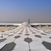 Designed by Massimiliano and Doriana Fuksas Architects, the airplane, atmosphere of earth, aviation, daytime, fixed link, flap, horizon, sand, sea, sky, wing, gray