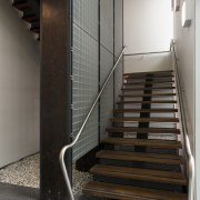 This boutique office development on a brownfields site architecture, floor, flooring, glass, handrail, interior design, stairs, wood, gray, black