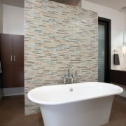 A Victoria &amp; Albert bathtub is the centerpiece architecture, bathroom, floor, flooring, home, interior design, plumbing fixture, room, sink, tap, tile, wall, gray